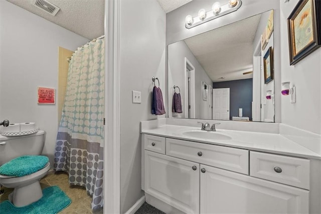 full bathroom featuring vanity, toilet, visible vents, and a textured ceiling