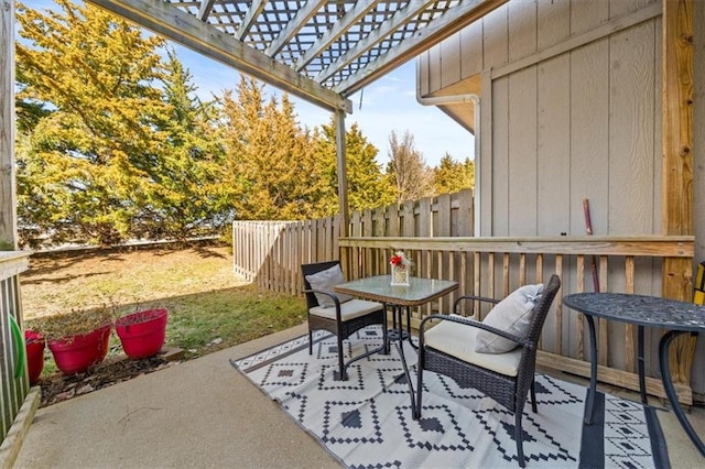 view of patio with outdoor dining space, a pergola, and fence