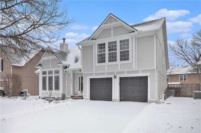 view of front of property with an attached garage, a chimney, and fence