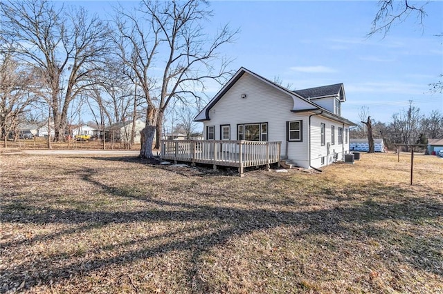 back of house with a yard, cooling unit, and a wooden deck