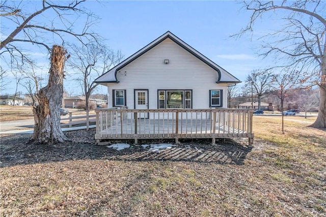 back of house featuring fence and a wooden deck