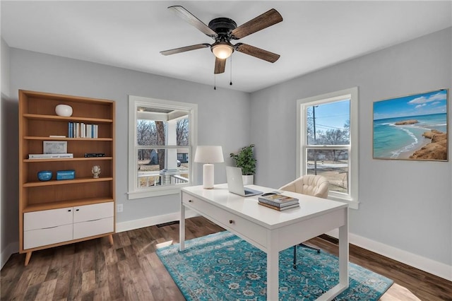 office space featuring dark wood-style floors, ceiling fan, and baseboards