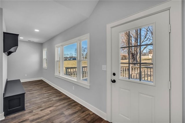 interior space with dark wood finished floors, plenty of natural light, baseboards, and recessed lighting