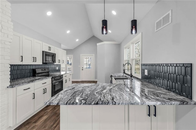 kitchen featuring visible vents, stainless steel appliances, stone counters, and white cabinetry