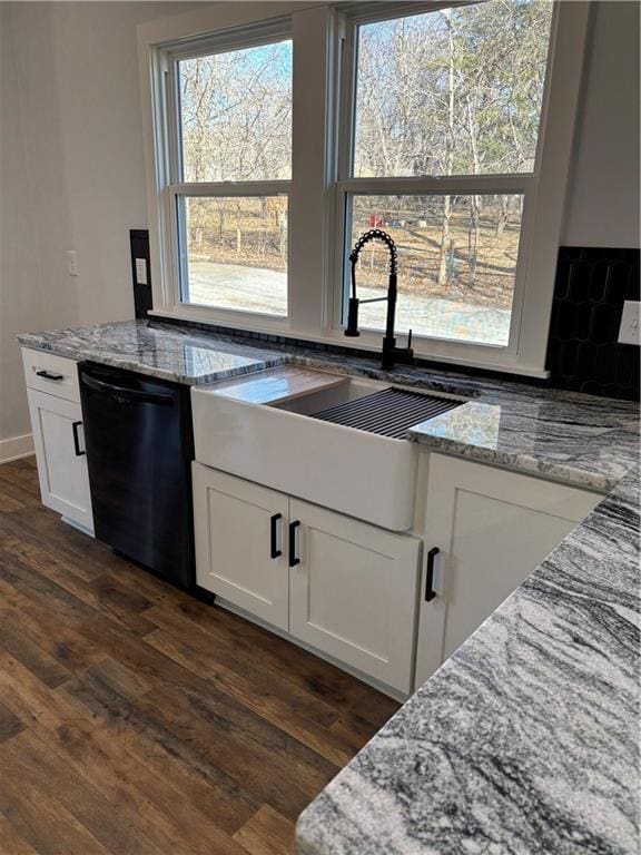 kitchen featuring light stone counters, dark wood finished floors, white cabinetry, and dishwasher