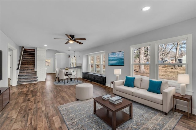 living area with stairs, baseboards, dark wood finished floors, and recessed lighting