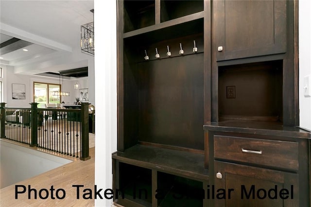 mudroom featuring beamed ceiling and hardwood / wood-style floors