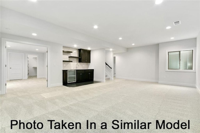 carpeted living room featuring wine cooler and wet bar