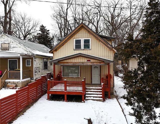 bungalow featuring covered porch and fence