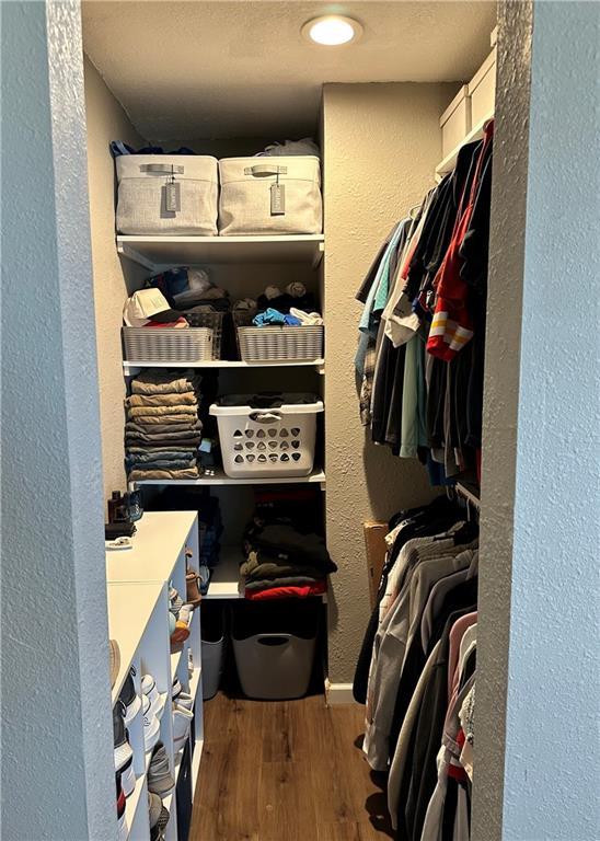 spacious closet featuring wood finished floors