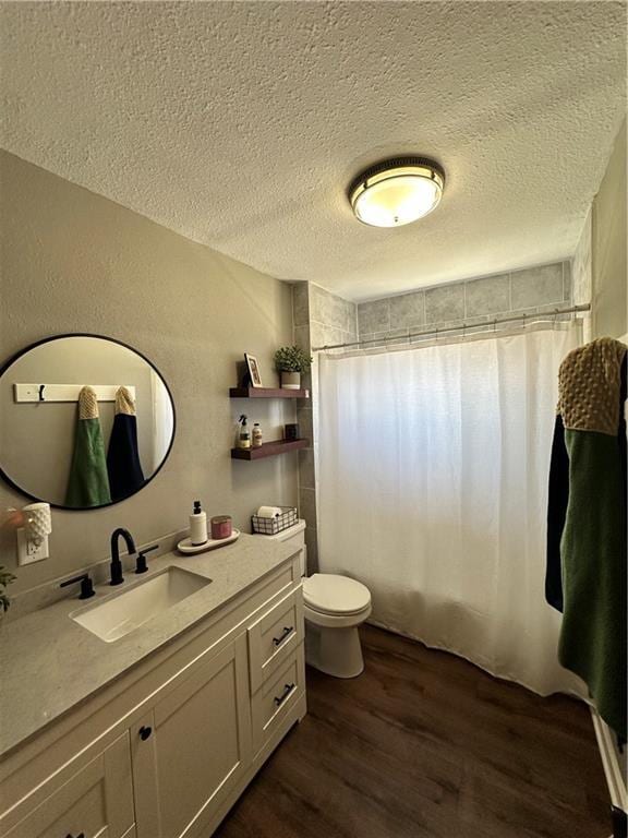 full bathroom featuring toilet, a textured ceiling, wood finished floors, and a shower with shower curtain