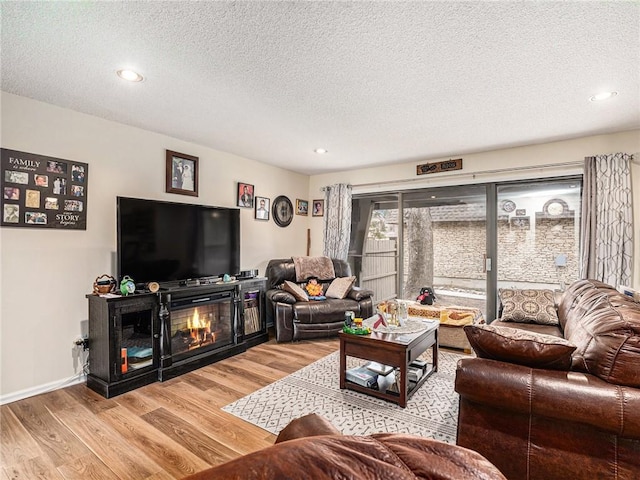 living room with hardwood / wood-style floors and a textured ceiling