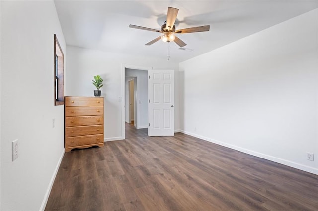 215 E Rose Ave, Caney, KS 67333 - unfurnished bedroom with ceiling fan, baseboards, and dark wood-style flooring