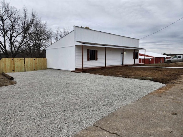 view of outbuilding with fence