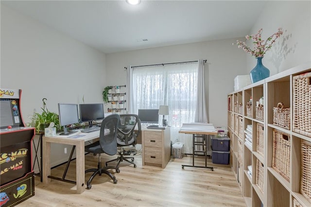 office space with visible vents and light wood-style flooring