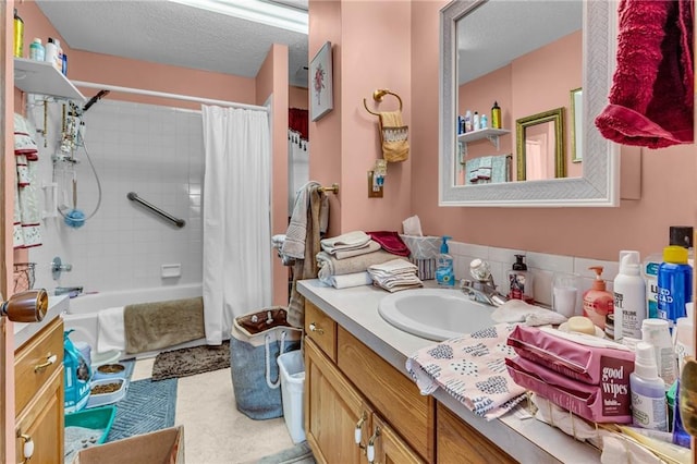 bathroom with vanity, shower / bath combination with curtain, and a textured ceiling