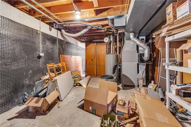 basement featuring water heater and heating unit