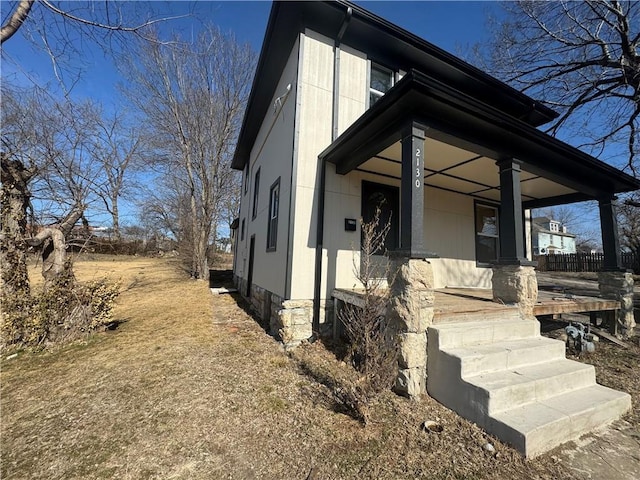 view of side of property featuring a porch