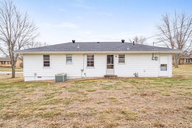 back of house with a yard and central air condition unit