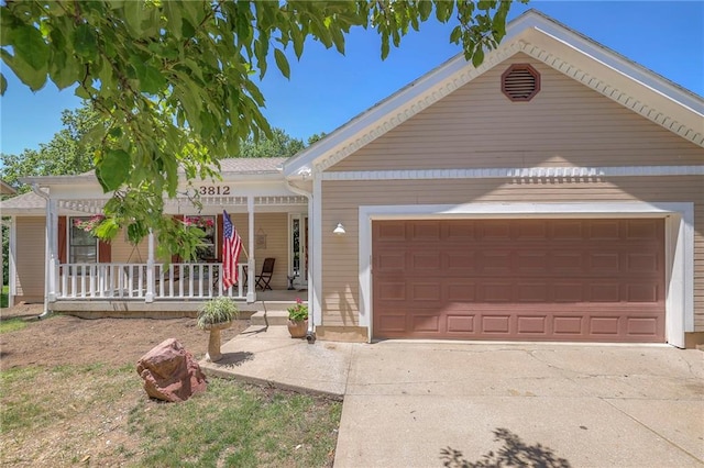 3812 SW Windemere Dr, Lees Summit, MO 64082 - view of front of house featuring a porch, a garage, and driveway