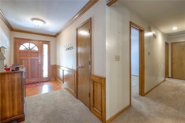 3812 SW Windemere Dr, Lees Summit, MO 64082 - foyer entrance with light colored carpet, ornamental molding, wainscoting, and a textured ceiling