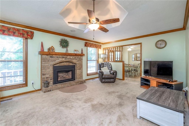 3812 SW Windemere Dr, Lees Summit, MO 64082 - carpeted living room with crown molding, a ceiling fan, healthy amount of natural light, a brick fireplace, and a textured ceiling