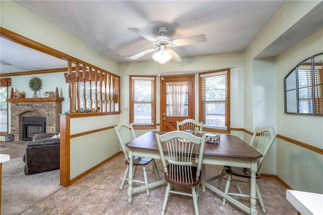 3812 SW Windemere Dr, Lees Summit, MO 64082 - dining room featuring a ceiling fan and a brick fireplace