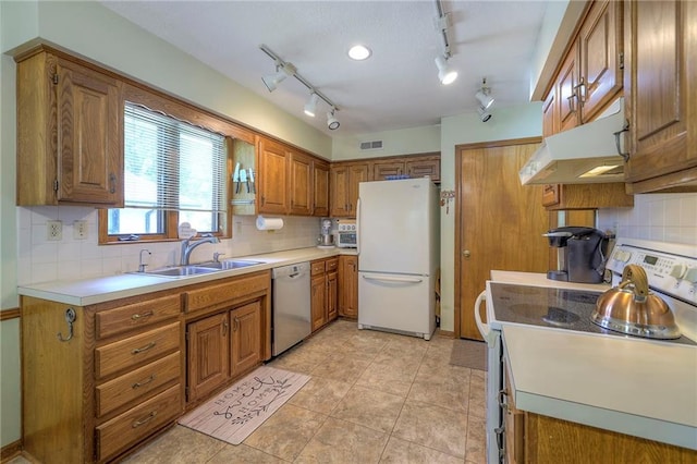 3812 SW Windemere Dr, Lees Summit, MO 64082 - kitchen featuring white appliances, under cabinet range hood, brown cabinets, and backsplash