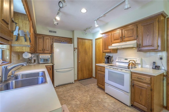 3812 SW Windemere Dr, Lees Summit, MO 64082 - kitchen featuring white appliances, under cabinet range hood, brown cabinets, and light countertops