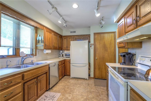 3812 SW Windemere Dr, Lees Summit, MO 64082 - kitchen featuring white appliances, brown cabinets, tasteful backsplash, and track lighting
