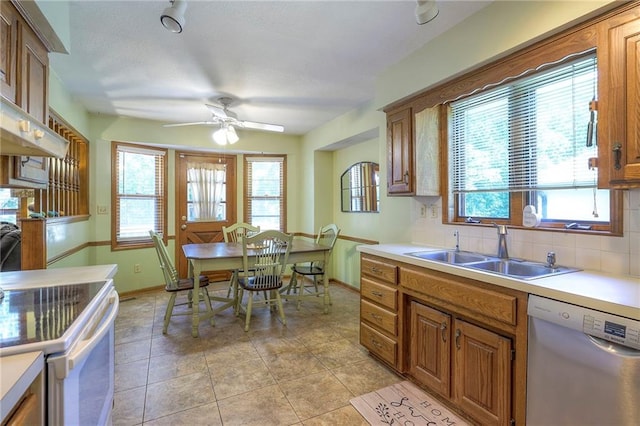 3812 SW Windemere Dr, Lees Summit, MO 64082 - kitchen featuring dishwashing machine, white electric stove, a ceiling fan, brown cabinets, and tasteful backsplash