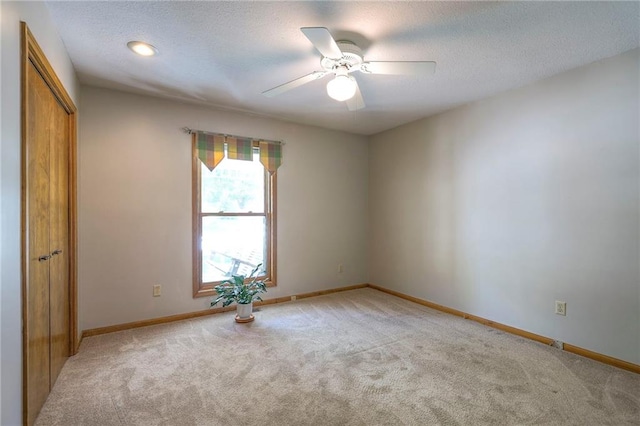 3812 SW Windemere Dr, Lees Summit, MO 64082 - spare room with light carpet, a ceiling fan, and a textured ceiling