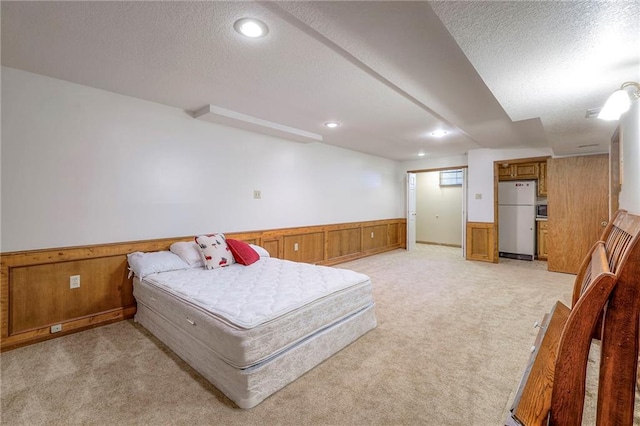 3812 SW Windemere Dr, Lees Summit, MO 64082 - bedroom featuring freestanding refrigerator, a wainscoted wall, light colored carpet, a textured ceiling, and wooden walls