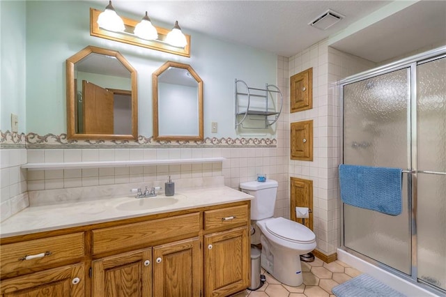 3812 SW Windemere Dr, Lees Summit, MO 64082 - bathroom with vanity, tile patterned flooring, a stall shower, and tile walls