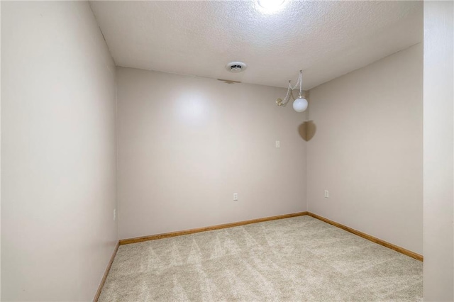 3812 SW Windemere Dr, Lees Summit, MO 64082 - spare room featuring carpet and a textured ceiling