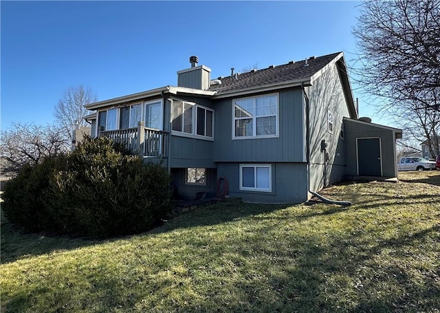 rear view of house featuring a yard