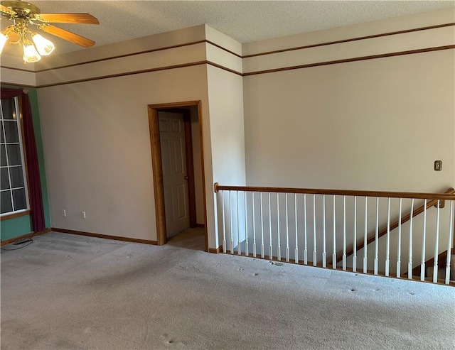 carpeted empty room featuring a textured ceiling