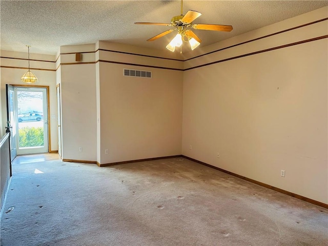 carpeted spare room with ceiling fan and a textured ceiling