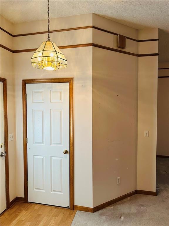 entrance foyer featuring wood-type flooring and a textured ceiling