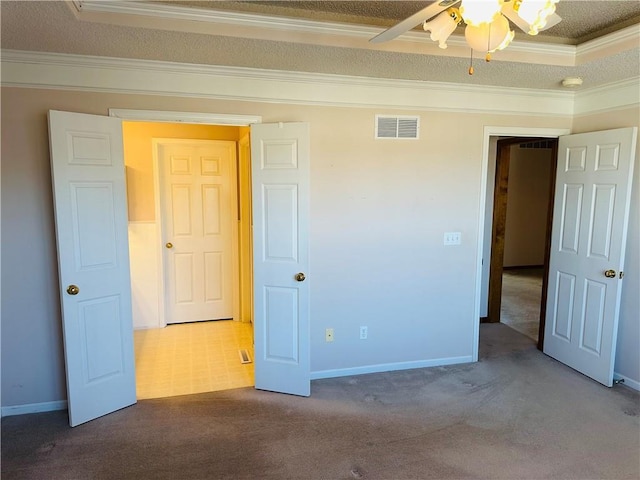 unfurnished bedroom featuring ornamental molding and carpet flooring