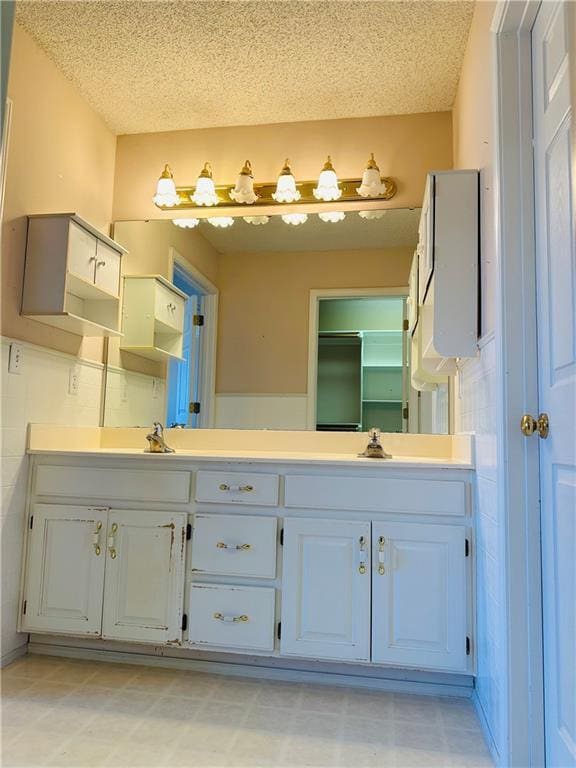 bathroom featuring vanity and a textured ceiling