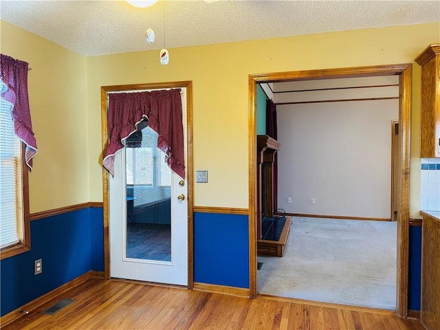 unfurnished bedroom featuring a textured ceiling and light wood-type flooring