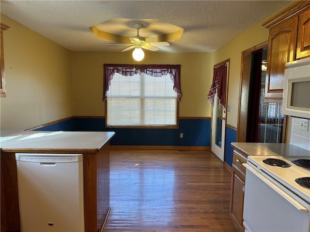 kitchen featuring ceiling fan, white appliances, a textured ceiling, and light wood-type flooring