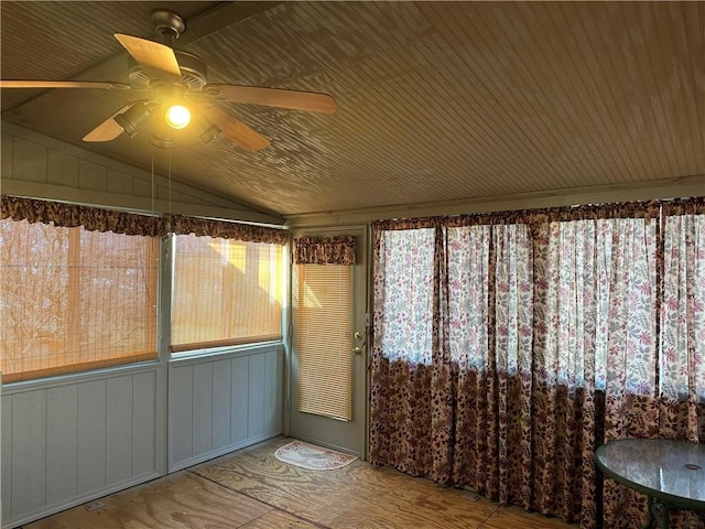 unfurnished sunroom featuring lofted ceiling and ceiling fan