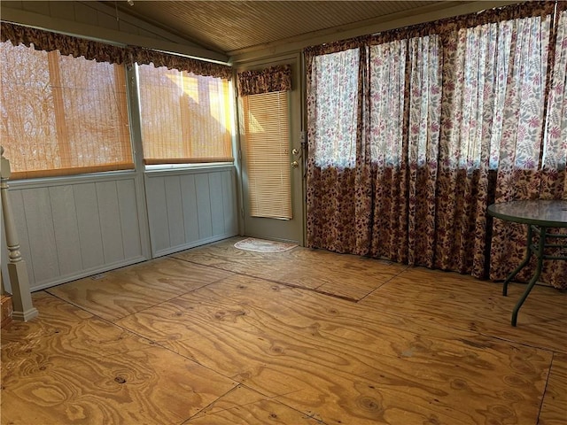 unfurnished room featuring lofted ceiling