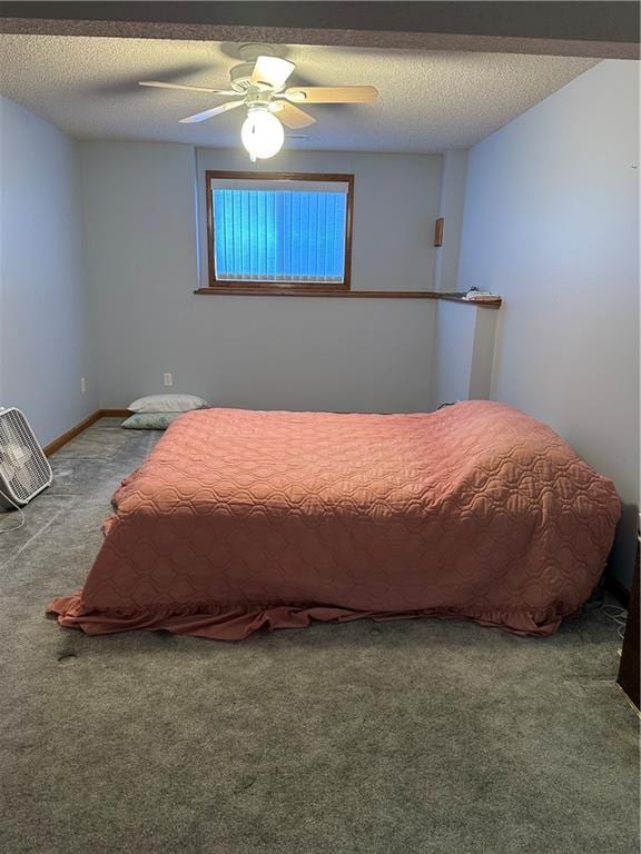 carpeted bedroom featuring ceiling fan and a textured ceiling