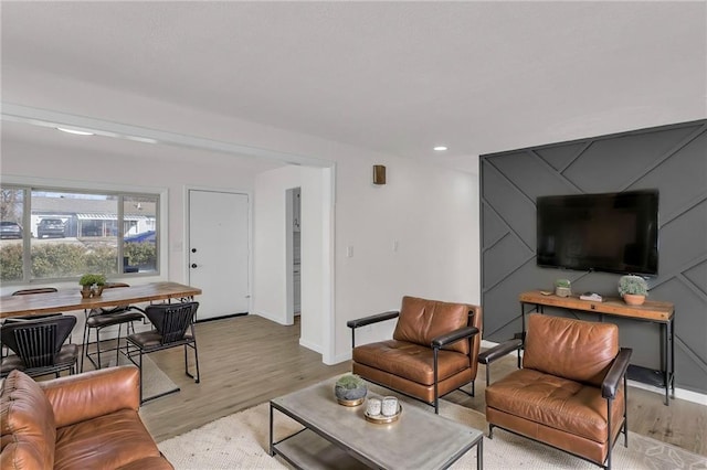 living room featuring recessed lighting, light wood-style flooring, and baseboards