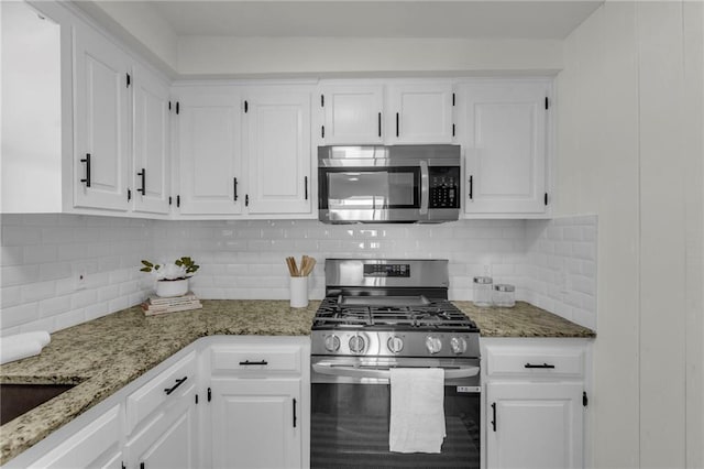 kitchen with white cabinetry, appliances with stainless steel finishes, and tasteful backsplash