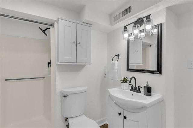 bathroom with a shower, visible vents, vanity, and toilet