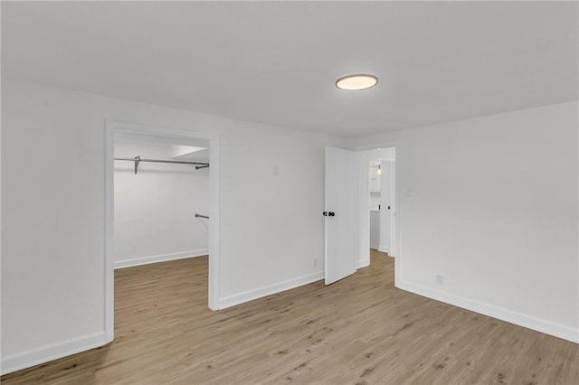 unfurnished room with baseboards and wood finished floors